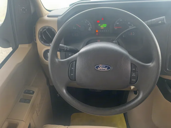 Driver's view inside an RV rental: Ford steering wheel, dashboard with gauges, 10,679 miles on odometer, and cruise controls.. Jayco Redhawk 2020