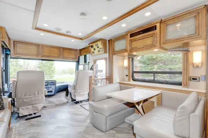Spacious rv rental interior featuring a modern cockpit, comfortable dinette seating, and ample overhead storage for travel.. Other Canyon Star 2020