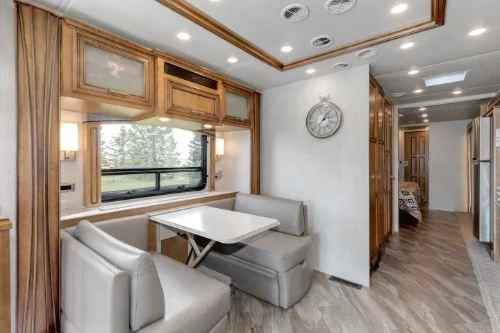 Explore this RV rental's spacious dinette and comfortable living space, featuring modern amenities and a bright window.. Other Canyon Star 2020
