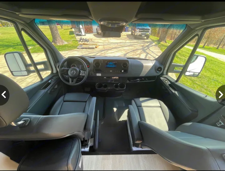 Explore in style with our RV rental. Interior view of a Mercedes-Benz Sprinter's spacious front cabin and dashboard.. Winnebago View 24J 2020