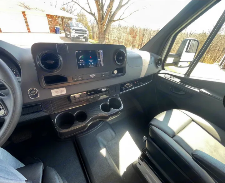 Modern RV rental interior view: dashboard with large screen, steering wheel, cup holders. Ready for adventure!. Winnebago View 24J 2020