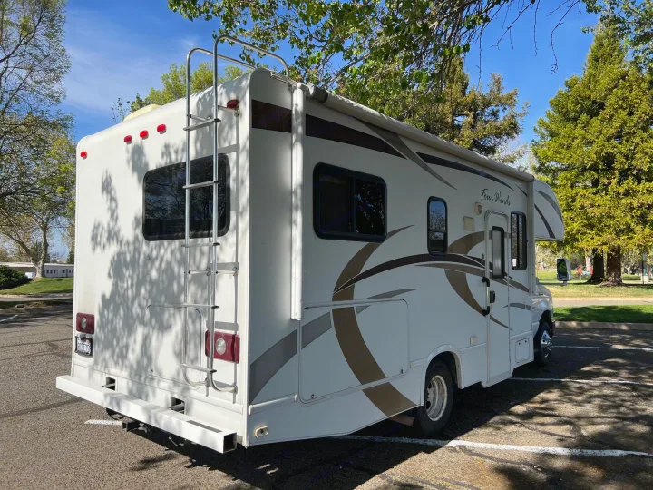 This white Four Winds RV rental, a compact motorhome, is parked and ready for your next road trip adventure.. Thor Four Winds 2013