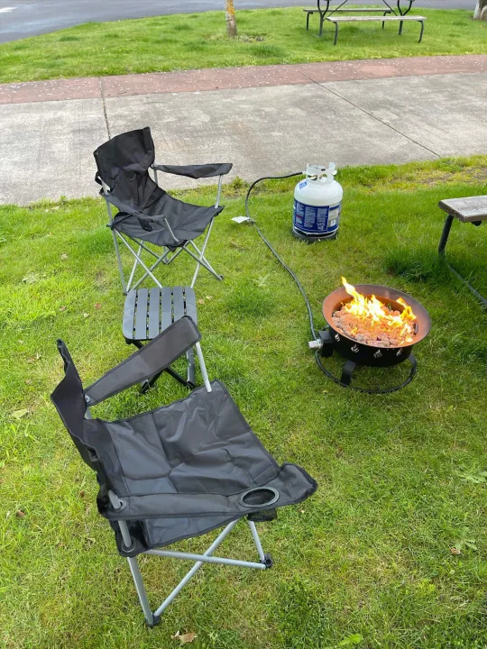 Cozy campsite setup with portable chairs, a propane fire pit, and a table, perfect for an RV rental outdoor experience.. Gulf Stream Enlighten 18BH 2022