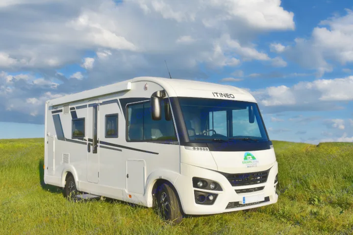 This white Itineo RV rental is parked in a green field under a blue sky with fluffy clouds.. ITINEO CS660 2022