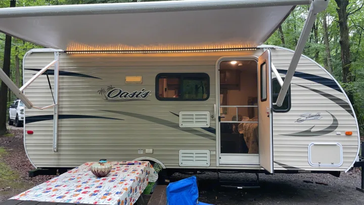 Fully set up with awning out and lights on.. Shasta Oasis 2018
