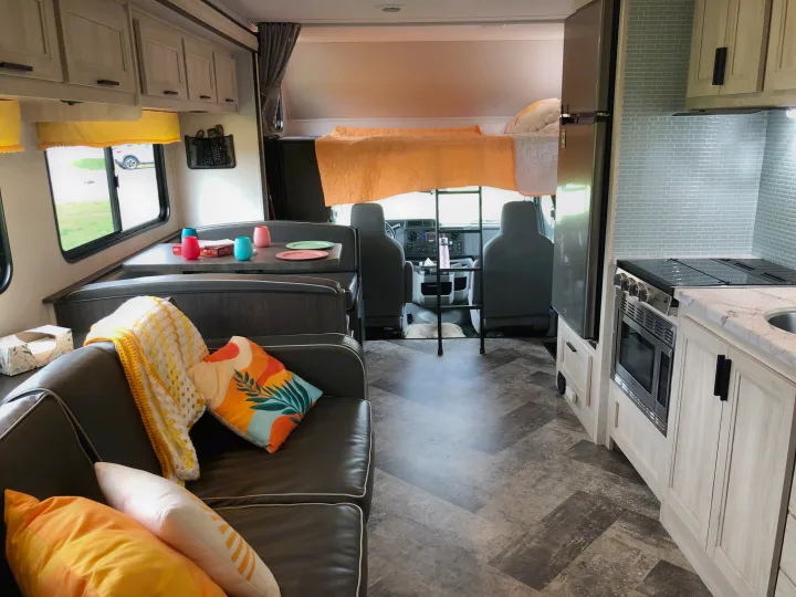 Spacious rv rental interior features a modern kitchen, cozy living area, and over-cab bed, ready for your next adventure.. Forester LE 2020