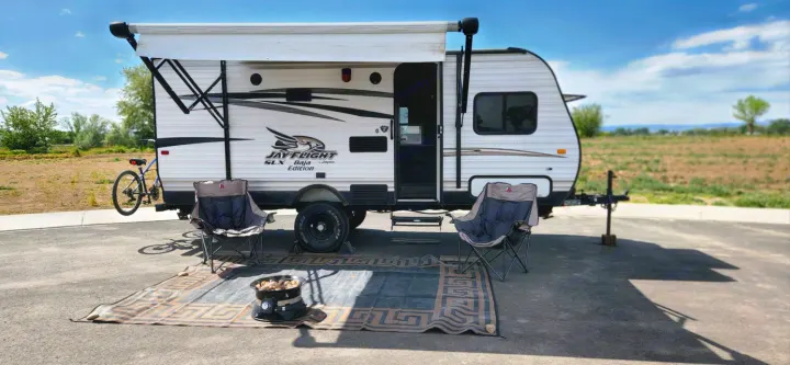RV rental travel trailer with awning, outdoor chairs, mat, and fire pit. Perfect for camping adventures.. Jayco Jay Flight SLX 2016