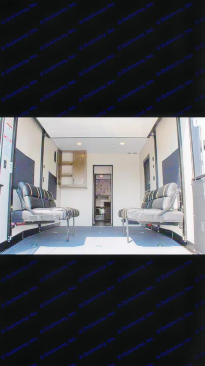 Interior of an RV rental: a spacious toy hauler with versatile black bench seats and durable floor.. Forest River Cherokee Wolf Pack Toy Hauler 2020