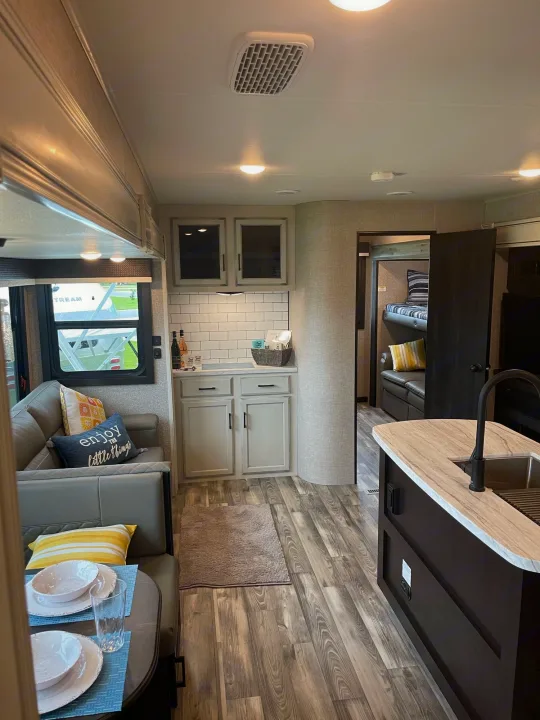 Cozy RV rental interior showcasing a modern living area, full kitchen, and a private bunk room.. Jayco Eagle HT 312BHOK 2022
