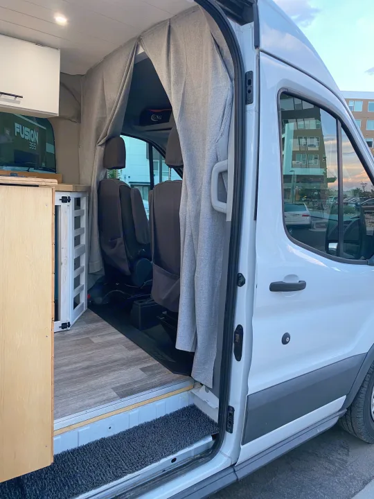 RV rental: Step inside this campervan! Wood flooring, custom cabinets, and privacy curtains create a cozy mobile space.. Ford Transit Custom 2015