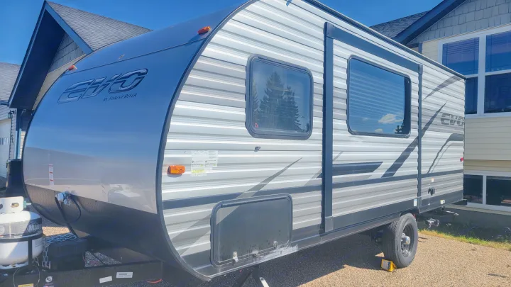 A sleek, gray and black Forest River EVO travel trailer, parked and ready for your next rv rental adventure.. Forest River EVO 2021