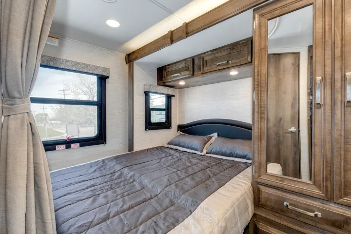 RV rental: Cozy bedroom featuring a comfortable bed, windows, and built-in cabinetry with a mirrored closet.. Jayco Melbourne 2022