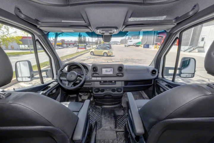 Interior of a spacious Mercedes Sprinter van, ideal for an RV rental or commercial use, showing dashboard & front seats.. Jayco Melbourne 2022