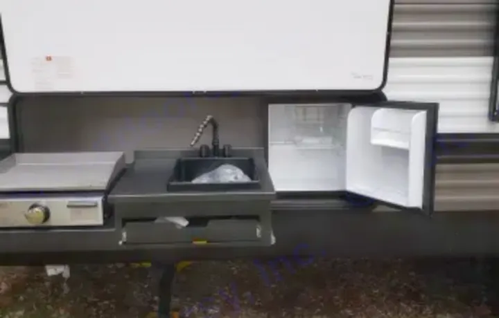 Outside kitchen with mini refrig. Forest River Palomino Puma XLE Lite 2021