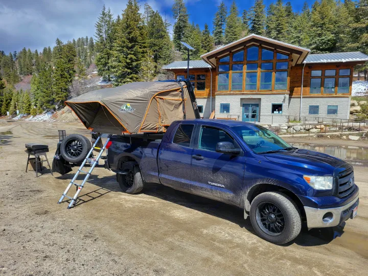 Explore the outdoors with this **RV rental** alternative: a Toyota Tundra overland truck and rooftop tent setup in a scenic mountain setting.. Toyota Tundra 2011