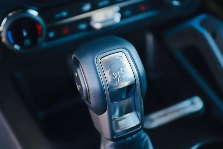 Close-up of a vehicle's automatic gear shifter with a Ford Bronco logo. Essential interior detail for your next rv rental.. Ford Bronco 2024