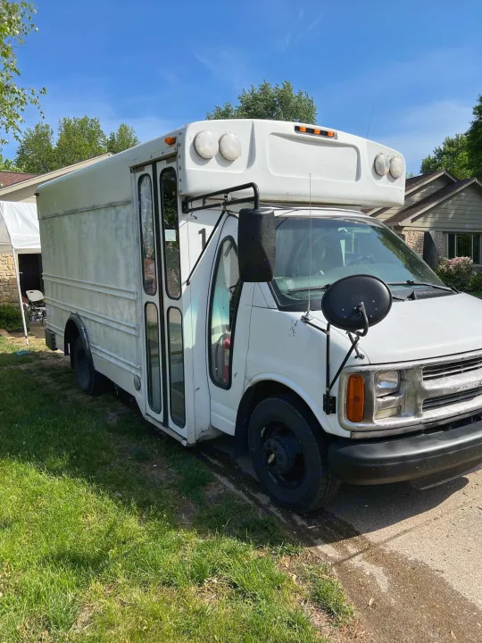 White converted shuttle van, ideal for RV rental. This camper van is parked & ready for your next adventure.. Chevy Express 3500 Mini Bus 2002