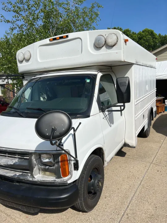 White commercial van, ideal for rv rental conversions, with extended roof and large front mirror, parked on a sunny driveway.. Chevy Express 3500 Mini Bus 2002