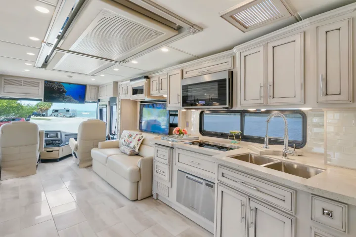 Spacious RV rental interior featuring a modern kitchen, living area, cockpit, and scenic beach/ocean views.. Ventana Ventana Motorhome 2022