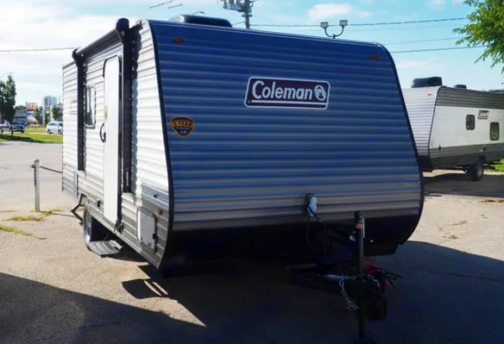 Front view: A grey Coleman travel trailer with a large logo, available for RV rental.. Coleman Coleman Lantern 2022