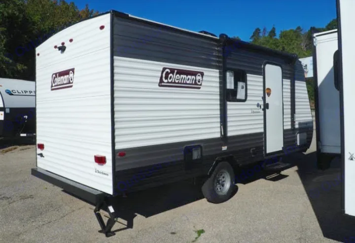 This white and gray Coleman travel trailer is a versatile RV rental option, seen parked outdoors.. Coleman Coleman Lantern 2022