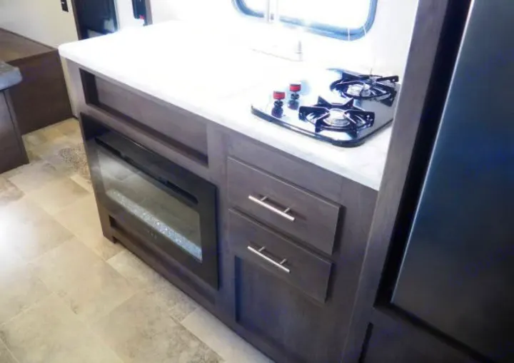 This RV rental features a compact kitchen: two-burner stove, electric fireplace, storage drawers, and a built-in refrigerator.. Coleman Coleman Lantern 2022