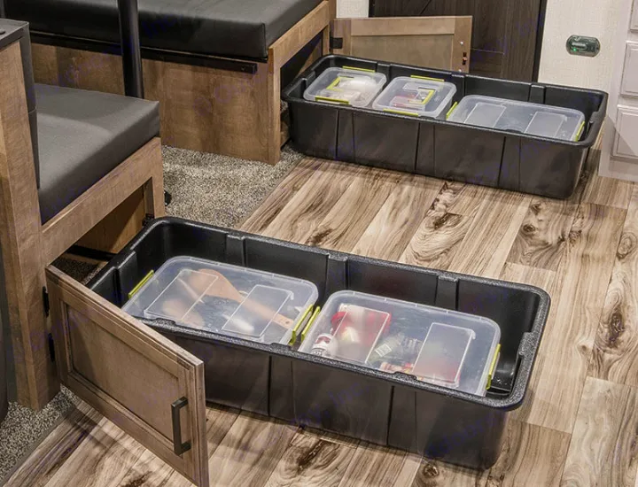 RV rental interior: Under-bench pull-out storage features large black bins on the floor, holding clear, organized containers.. Venture Stratus VBH261 2022