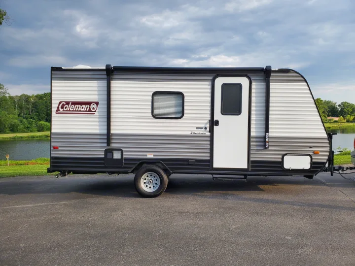 Coleman travel trailer, a great RV rental for lakeside adventures under cloudy skies.. Coleman LANTERN LT 17B 2022