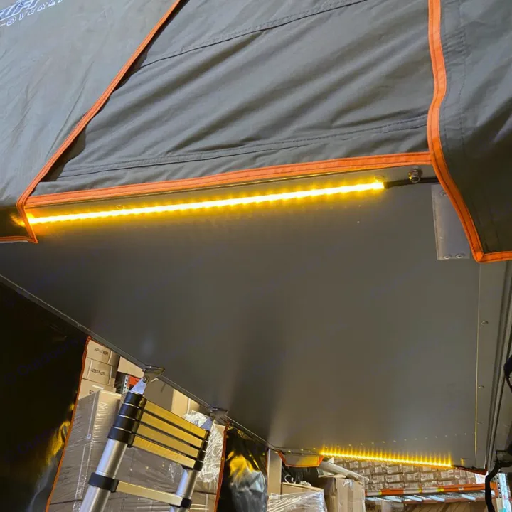 Bright LED strip lighting illuminates the underside of this rooftop tent, perfect for an RV rental or camping setup.. Toyota Tundra 2011