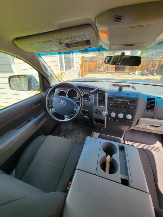 Spacious Toyota truck interior, showing dashboard, steering wheel, and seating. Ideal for an rv rental adventure.. Toyota Tundra 2011