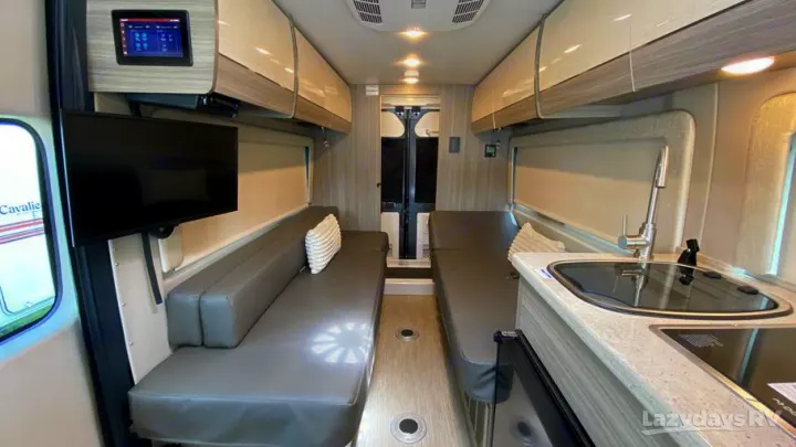 RV rental interior: comfy lounge seating, TV, and kitchenette with sink/cooktop. Ready for adventures!. Entegra Coach Ethos 2021