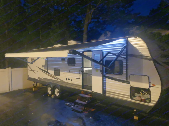 Nighttime RV rental! Illuminated travel trailer with open door & awning lights for your adventure.. Jayco Flight 2019