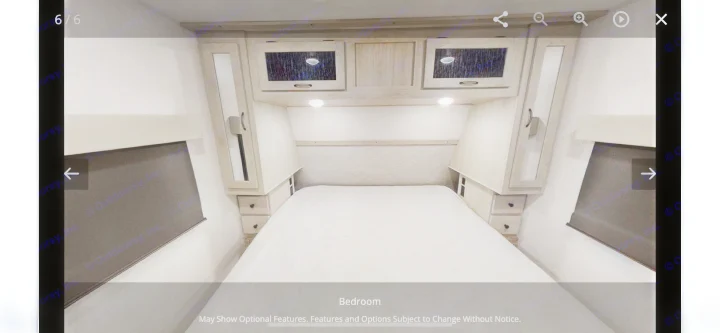 Cozy RV rental bedroom featuring a comfortable bed, overhead cabinets with lighting, and convenient side storage.. Forest River Other 2022