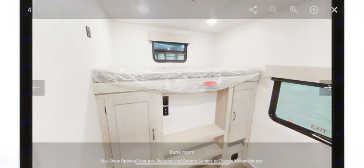 Interior of an RV rental bunk room, featuring a cozy bunk bed with plastic-covered mattress, storage, and an emergency exit window.. Forest River Other 2022