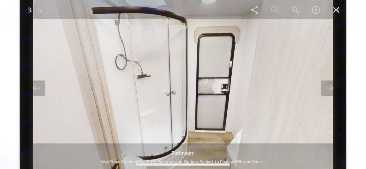 RV rental bathroom featuring a curved shower enclosure and the main entry door. Practical amenities for mobile living.. Forest River Other 2022
