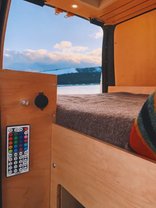 Cozy RV rental interior with Govee remote, charging port, and scenic lake/mountain view.. Ford Transit Connect 2010
