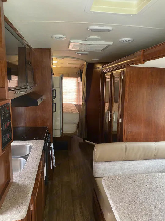 Step inside this comfortable rv rental! Features a well-equipped kitchen, dining area, and cozy bedroom in the back.. Forest River 23DS 2018