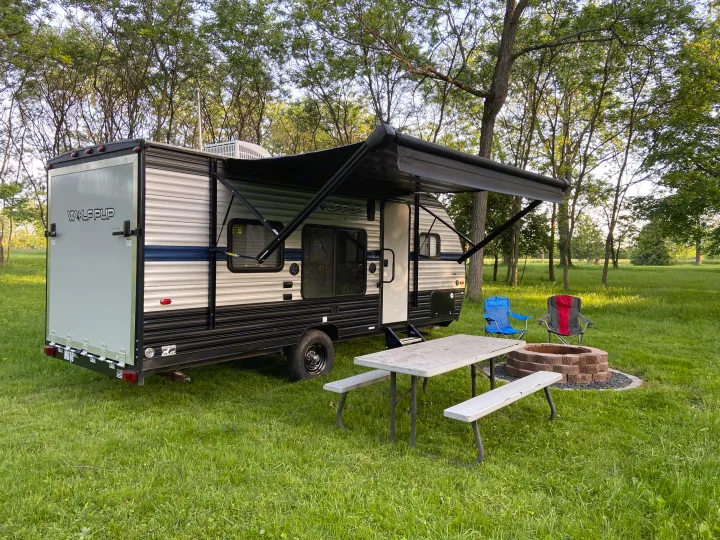 This RV rental offers a spacious campsite with a Wolf Pup travel trailer, extended awning, picnic table, and fire pit.. Forest River Cherokee Wolf Pup 2019