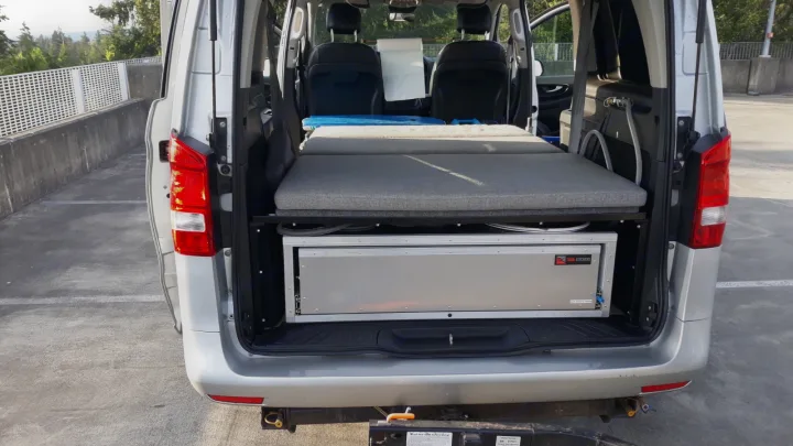 RV rental: Back of a camper van with a modular bed and pull-out TK Trail Kitchens unit, ideal for adventure & road trips.. Mercedes Metris 2016