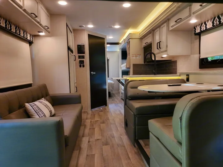 Modern RV rental interior with a spacious living area, kitchen, and dinette, perfect for travel comfort.. Jayco Alante 2022