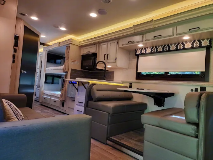 Step inside this RV rental: a bright, modern interior with a well-equipped kitchen, comfy lounge, and bunk beds.. Jayco Alante 2022