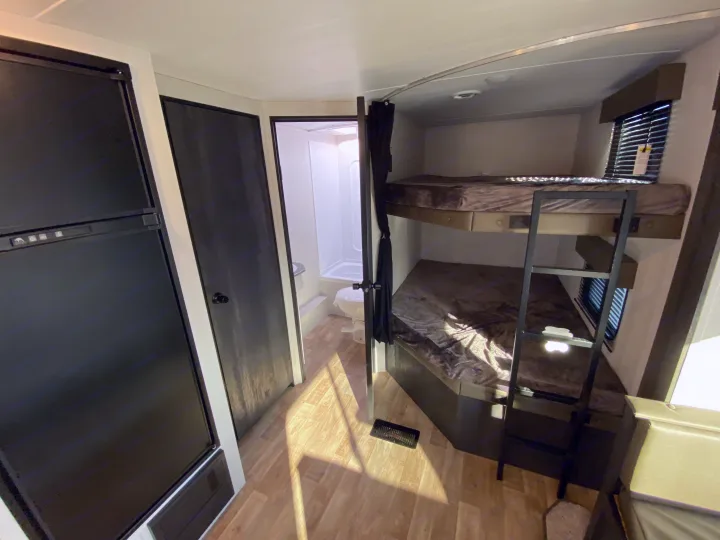 This RV rental offers a compact kitchen with a fridge, full bathroom, and bunk beds for family comfort.. Keystone RV Hideout 2022