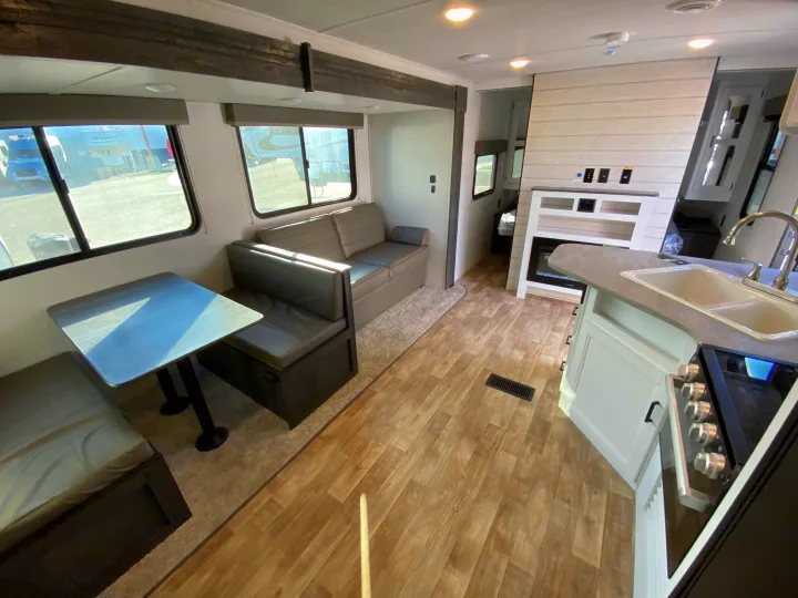 Comfortable RV rental interior with dining, living, and kitchen areas, perfect for your next adventure.. Keystone RV Hideout 2022