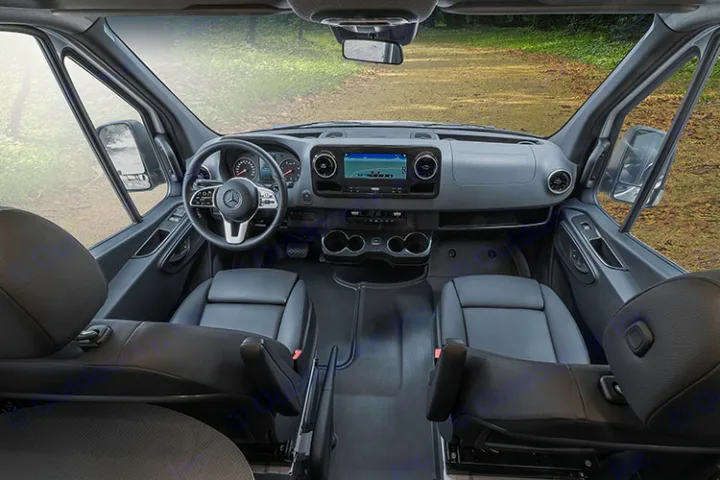 View the comfortable front cabin of this Mercedes-Benz Sprinter RV rental, with its modern dashboard, steering wheel, and clear road ahead.. Winnebago Revel 2022