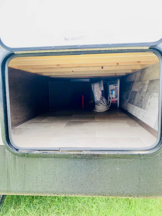 Open RV rental storage bay, showcasing spacious interior for all your travel gear and camping essentials.. Coleman Lantern 2021