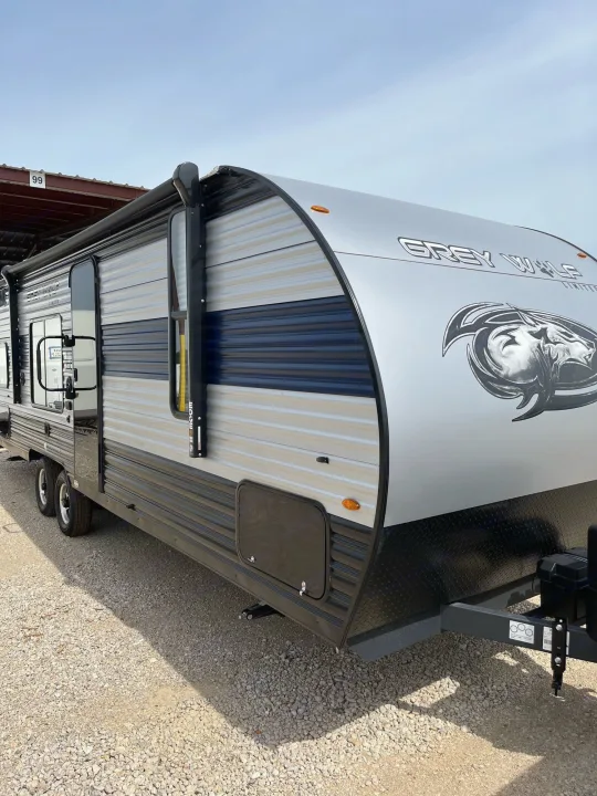 Discover this Grey Wolf RV rental: a modern, two-axle travel trailer, gray with a blue stripe, perfect for camping.. Forest River Cherokee Grey Wolf Special Edition 2022