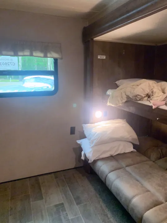 Step inside this RV rental: comfortable bunk beds, a bright reading light, and a window view of nature await your next adventure.. Palomino Puma 2018