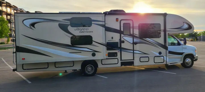 Bright Jayco Greyhawk Class C rv rental motorhome with a slide-out extended, parked at sunset, ready for your next adventure.. Jayco Greyhawk 2015