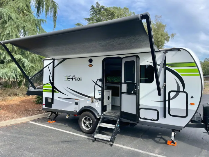 A white Flagstaff E-Pro travel trailer with an extended awning, perfect for an rv rental adventure.. Forest River Flagstaff E-Pro 2020
