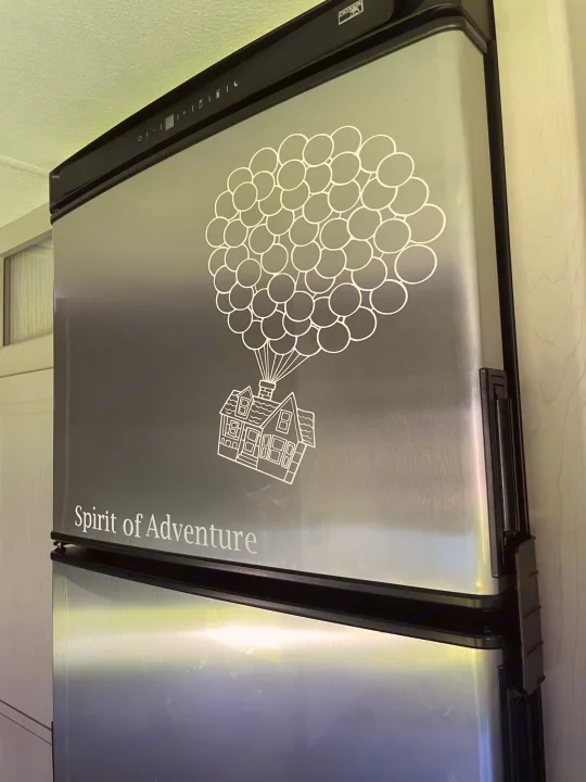 This RV rental features a Norcold refrigerator with an "Up" movie house & balloons decal. "Spirit of Adventure" written below.. Heartland Prowler 2021
